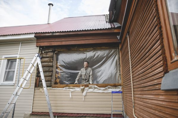 Man repairing the windows of his house